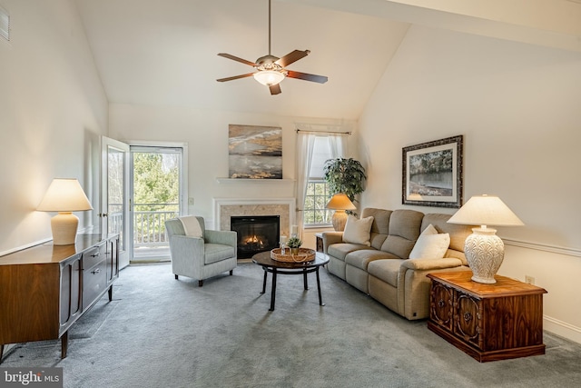 living room with visible vents, high vaulted ceiling, a ceiling fan, a glass covered fireplace, and carpet flooring