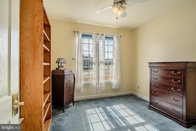 interior space featuring carpet flooring, a ceiling fan, and baseboards