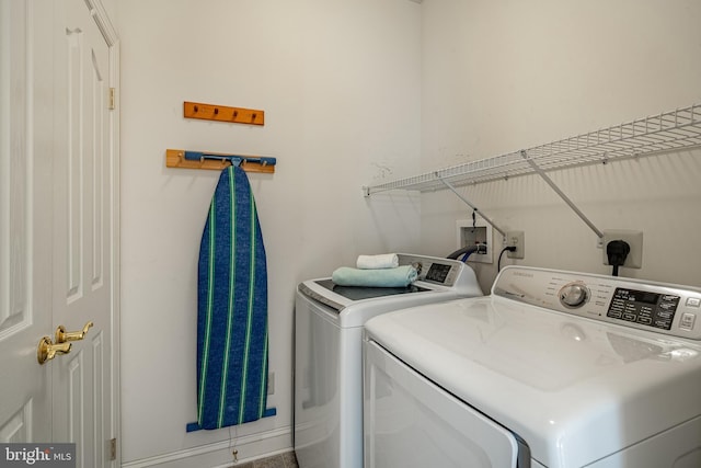 washroom with laundry area and washer and clothes dryer