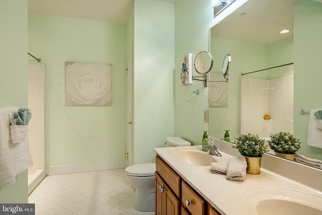 full bathroom featuring tile patterned flooring, double vanity, a shower, and a sink