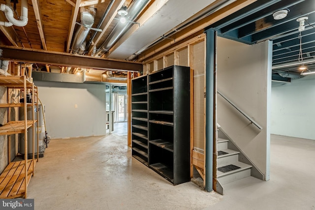 unfinished below grade area with stairway and gas water heater