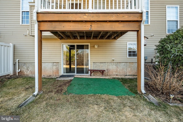 property entrance with a lawn