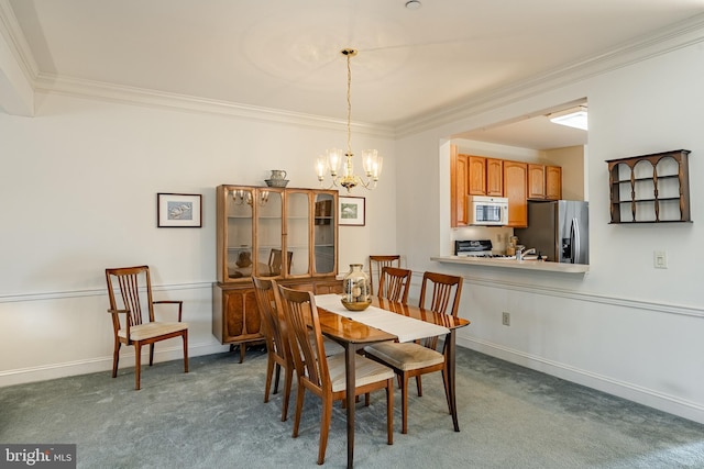 carpeted dining space with a notable chandelier, baseboards, and ornamental molding