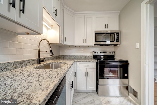 kitchen featuring visible vents, a sink, appliances with stainless steel finishes, white cabinetry, and marble finish floor