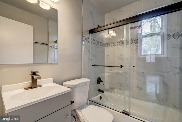 full bath featuring enclosed tub / shower combo, toilet, and vanity