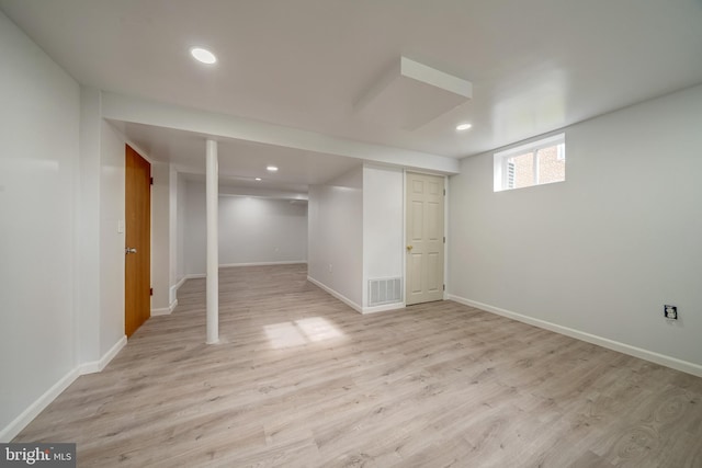 basement with recessed lighting, light wood-style floors, visible vents, and baseboards