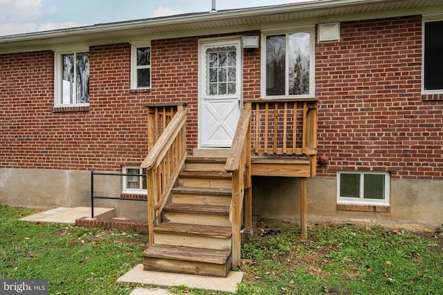 entrance to property featuring brick siding