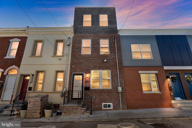 townhome / multi-family property featuring brick siding