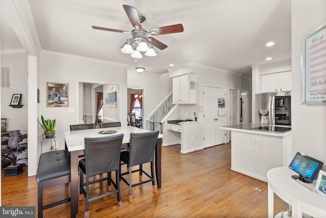 dining space with stairway, wood finished floors, recessed lighting, ornamental molding, and ceiling fan