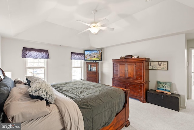 bedroom with light colored carpet, a ceiling fan, a raised ceiling, and lofted ceiling