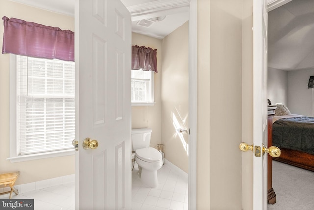 ensuite bathroom with tile patterned floors, visible vents, toilet, ensuite bathroom, and baseboards