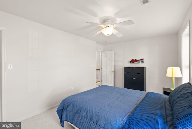 bedroom with visible vents, baseboards, carpet, and a ceiling fan