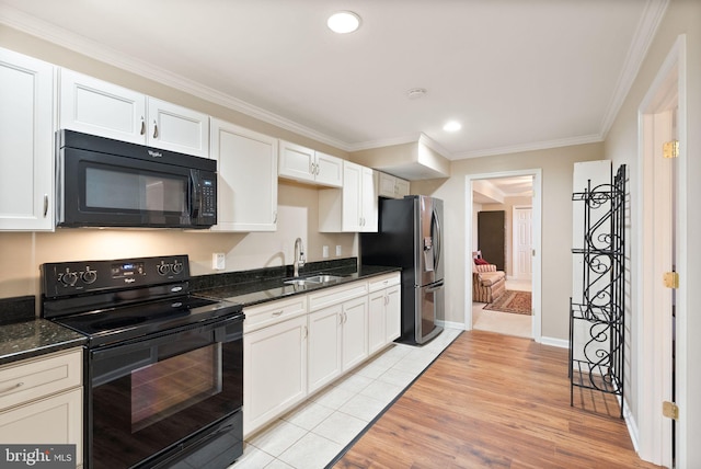 kitchen featuring black appliances, crown molding, light wood-type flooring, white cabinetry, and a sink