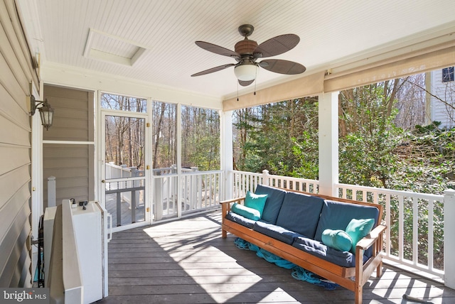 deck with an outdoor living space and ceiling fan