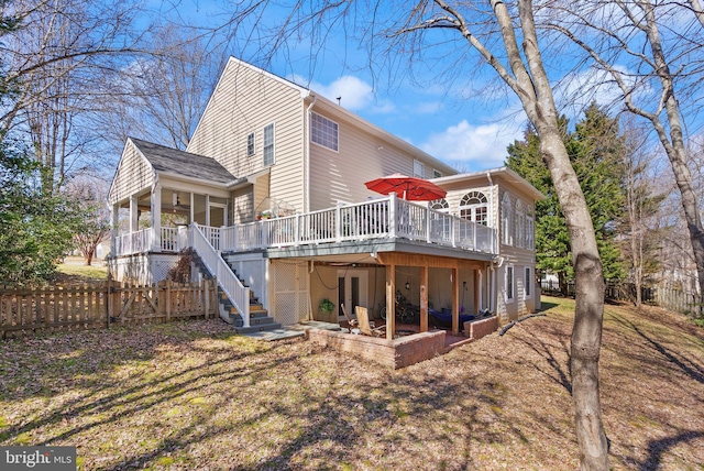 back of property featuring stairs, fence, and a wooden deck