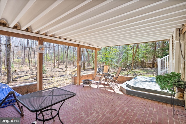 sunroom featuring beam ceiling