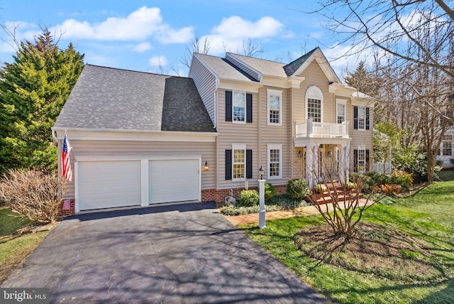 view of front of property with aphalt driveway, a balcony, an attached garage, and a shingled roof