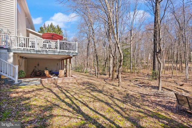 view of yard with a deck and stairs