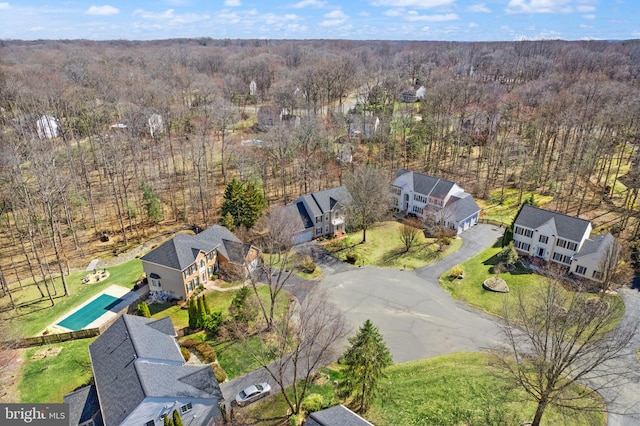 drone / aerial view featuring a forest view