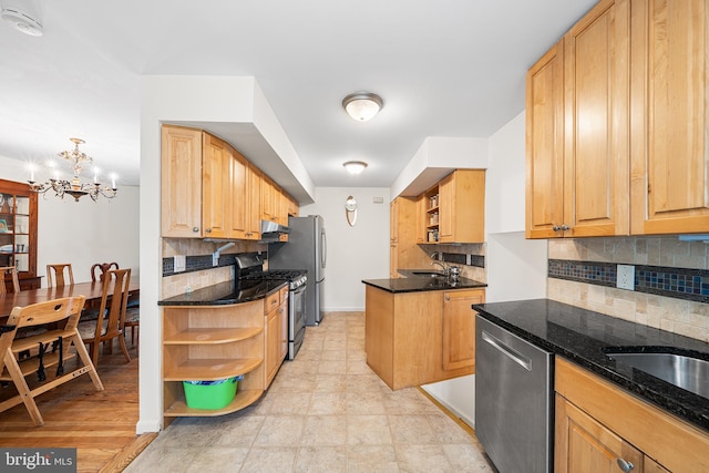 kitchen featuring appliances with stainless steel finishes, open shelves, decorative backsplash, a chandelier, and a sink
