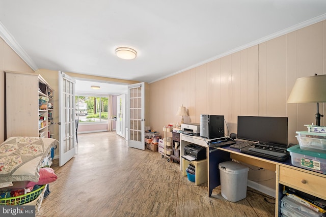 office space with french doors, crown molding, and light wood-type flooring