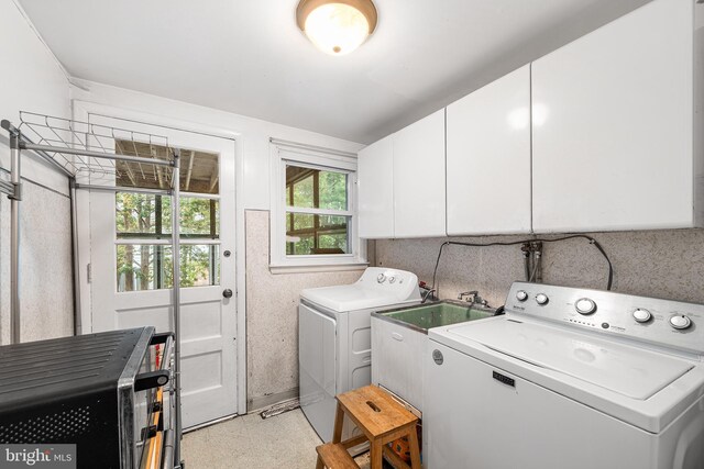 laundry area with cabinet space and independent washer and dryer