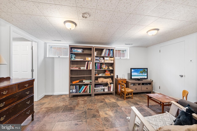 living area featuring baseboards