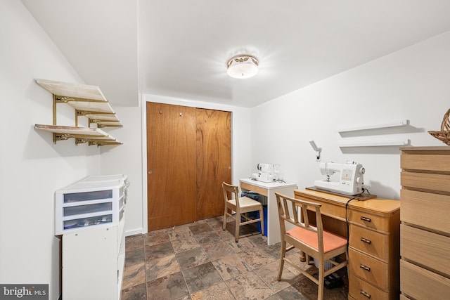 office featuring stone finish flooring and baseboards