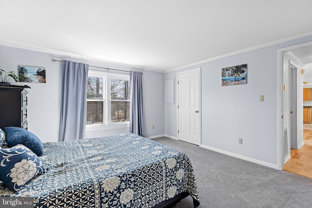 carpeted bedroom featuring baseboards and ornamental molding