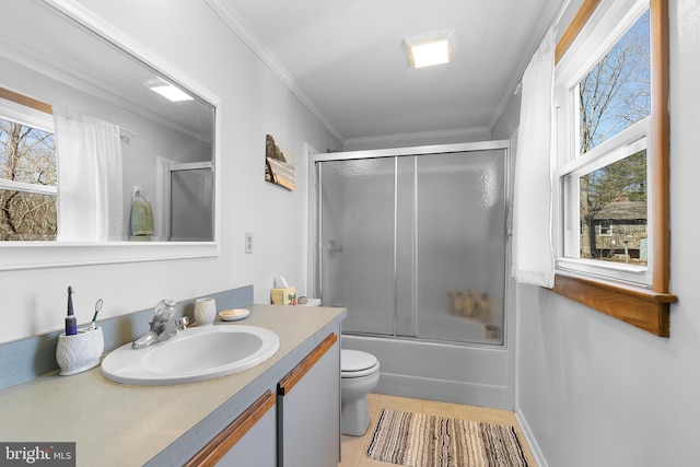 full bath featuring a wealth of natural light, enclosed tub / shower combo, ornamental molding, and vanity