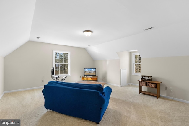 interior space with visible vents, carpet floors, baseboards, and vaulted ceiling