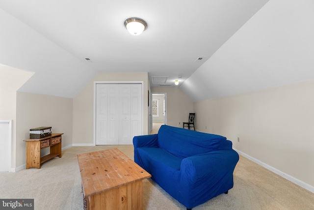 sitting room with baseboards, light colored carpet, lofted ceiling, and attic access