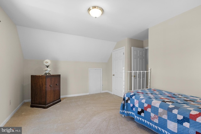 bedroom with baseboards, carpet floors, and vaulted ceiling