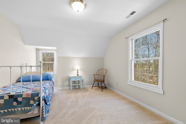 carpeted bedroom featuring visible vents, baseboards, and vaulted ceiling