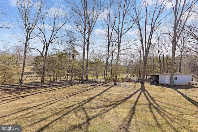 view of yard with an outdoor structure and fence