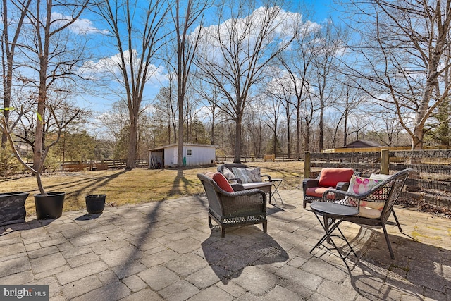 view of patio / terrace featuring a fenced backyard, an outdoor living space, and an outdoor structure