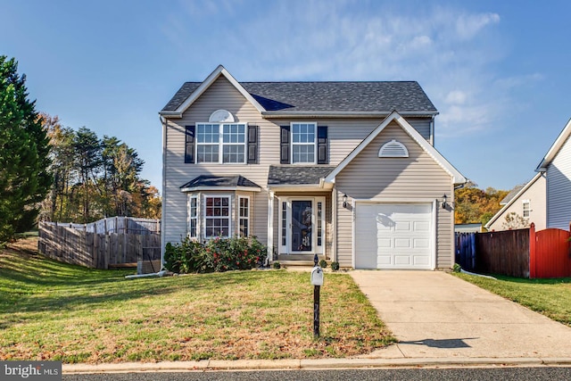 traditional home with driveway, a shingled roof, a front lawn, and fence