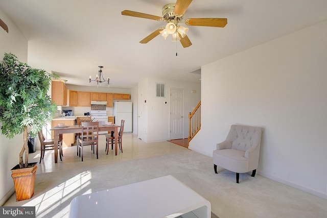 living room with stairs, ceiling fan with notable chandelier, and visible vents