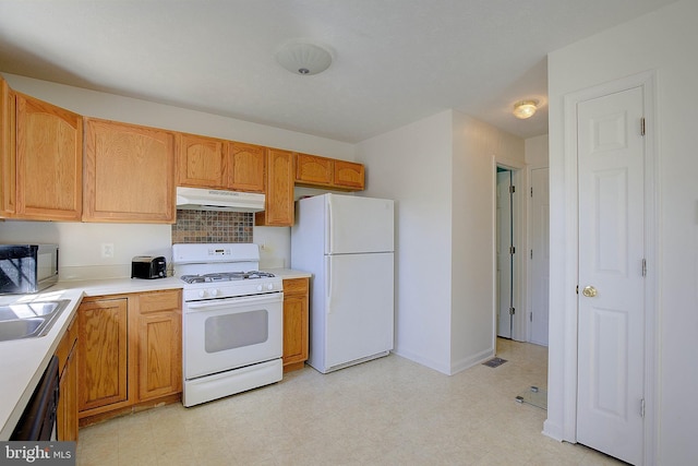 kitchen featuring under cabinet range hood, white appliances, light floors, and light countertops