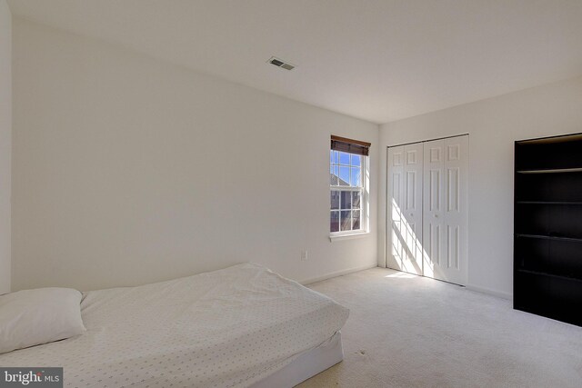 bedroom featuring visible vents and carpet flooring