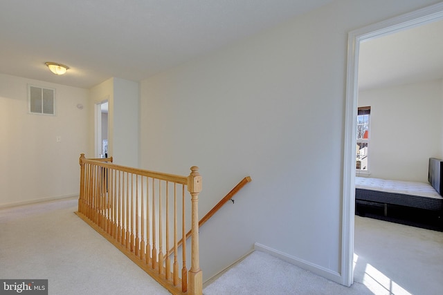 stairs featuring carpet flooring, baseboards, and visible vents