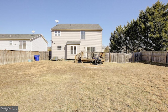 rear view of house with central air condition unit, a fenced backyard, a lawn, and a wooden deck