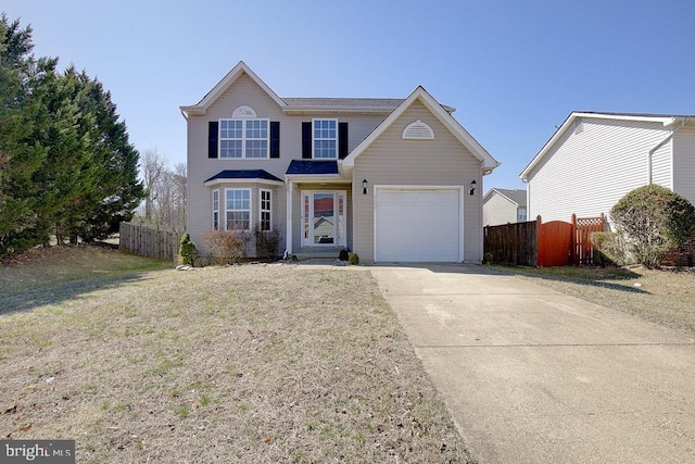 traditional-style home featuring concrete driveway, fence, a garage, and a front lawn