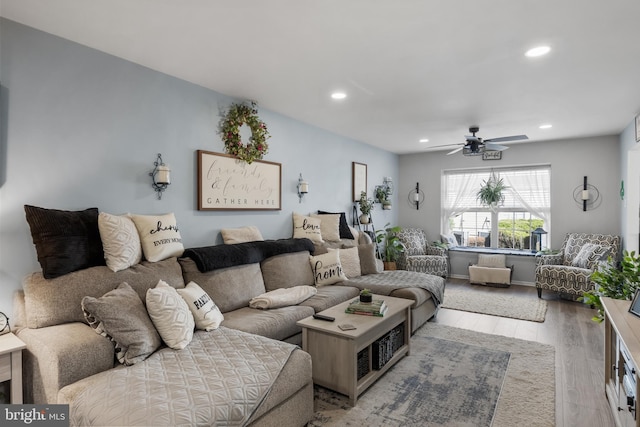 living area with recessed lighting, light wood-style flooring, and ceiling fan