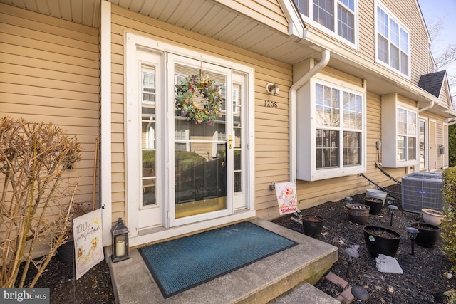 doorway to property with central AC unit