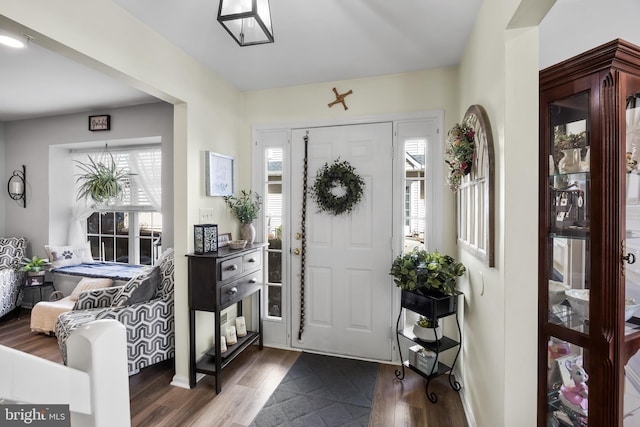 entryway with dark wood finished floors and plenty of natural light