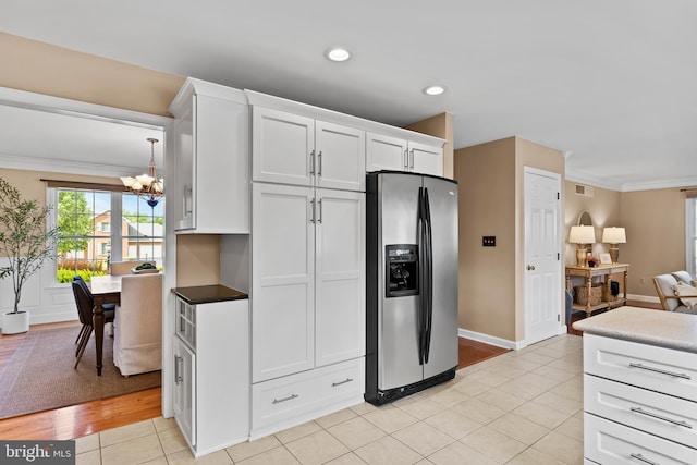 10 Silver Maple Dr, Boiling Springs, PA 17007 - kitchen featuring stainless steel fridge with ice dispenser, a chandelier, crown molding, open floor plan, and white cabinetry
