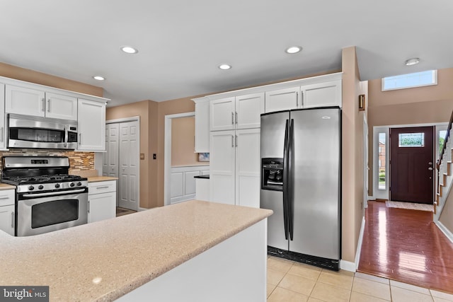 10 Silver Maple Dr, Boiling Springs, PA 17007 - kitchen featuring appliances with stainless steel finishes, white cabinetry, decorative backsplash, light tile patterned flooring, and recessed lighting