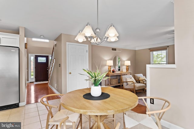 10 Silver Maple Dr, Boiling Springs, PA 17007 - dining area with light tile patterned floors, a chandelier, baseboards, and ornamental molding