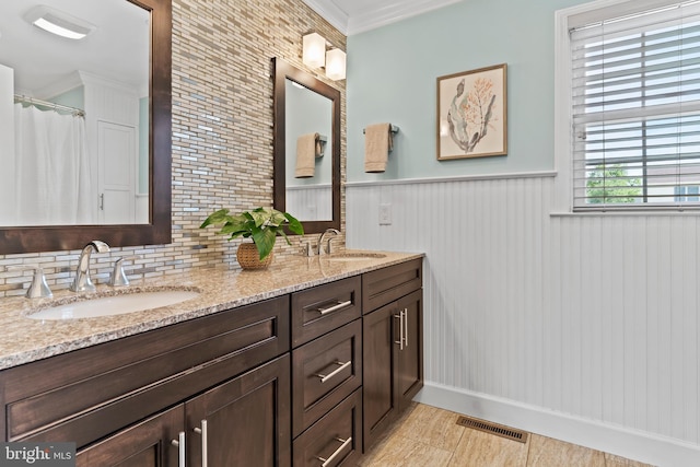 10 Silver Maple Dr, Boiling Springs, PA 17007 - bathroom with double vanity, ornamental molding, a wainscoted wall, backsplash, and wood finished floors